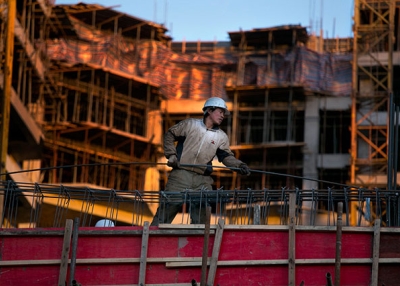 A Chinese construction worker sets rebar on an apartment building under construction as a development and a real estate boom takes hold in Ulaanbaatar, Mongolia, in October 2012. (Paula Bronstein/Getty Images)