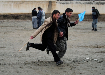 Supporters run to get a spot near the stage at an election rally for presidential candidate Abudullah Abdullah on the outskirts of Kabul on April 2, 2014, the last day of campaigning by Afghanistan's presidential candidates. (Roberto Schmidt/AFP/Getty Images)