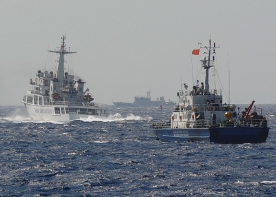 This picture taken on May 14, 2014 shows a Chinese coast guard vessel (L) followed by a Vietnamese coast guard ship (R) near the area of China's oil drilling rig in disputed waters in the South China Sea. (Hoang Dinh Nam/AFP/Getty Images)