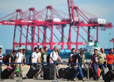Chinese nationals disembark from the passenger vessel Wuzhishan after the ship arrived at the Xiuying Port on May 20, 2014 in Haikou, China. The first group of violence-stricken Chinese workers, 989 in total, arrived at Xiuying Port from Vietnam to escape rioters protesting against a Chinese oil rig that was erected in an area of the South China Sea that they believe to be Vietnamese territory. (ChinaFotoPress/Getty Images)