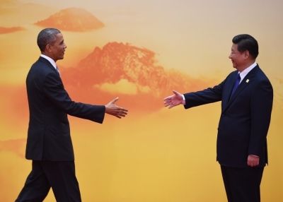 U.S. President Barack Obama is greeted by Chinese President Xi Jinping as he arrives for the Asia-Pacific Economic Cooperation (APEC) leaders meeting at Yanqi Lake, north of Beijing on November 11, 2014. (Greg Baker/AFP/Getty Images)