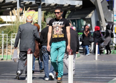 An Iranian youth listens to music as he walks through central Tehran. (Atta Kenare/AFP/Getty Images)