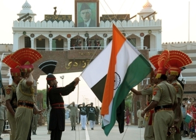 Pakistani Rangers, in black, and Indian Border Security Force (BSF) personnel perform the daily retreat ceremony on the India-Pakistan Border at Wagah on September 17, 2014. (Narinder Nanu/Getty Images)