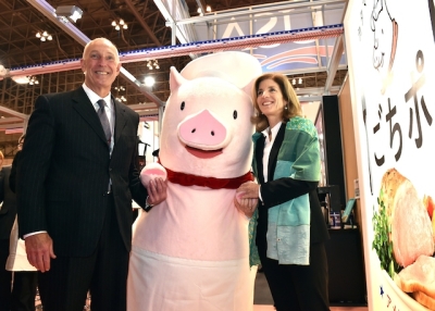 US Ambassador to Japan Caroline Kennedy (R) smiles with US Meat Export Federation (USMEF) president Philip Seng (L) and the mascot for US pork 'Gochipo' (C) as she inspects the US booth at the annual 'Foodex' food exhibition in Chiba, suburban Tokyo on March 3, 2015. (Yoshikazu Tsuno/AFP/Getty Images)