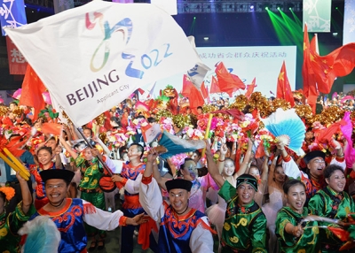 Chinese people wearing traditional costumes gather to celebrate as Beijing is announced as the host city for the 2022 Winter Olympic Games, in Shijiazhuang, the capital of northern China's Hebei province on July 31, 2015. (STR/AFP/Getty Images)