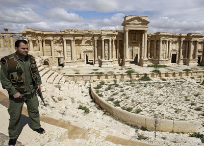 A Syrian policeman patrols Greco-Roman ruins in the ancient city of Palmyra, Syria, on March 14, 2014, before Islamic State forces seized the city the following year. (Joseph Eid/AFP/Getty Images)