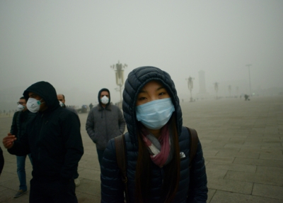 Visitors wearing face masks brave air pollution in Beijing's Tiananmen Square. (Wang Zhen/AFP/Getty Images)