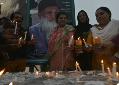 Pakistani supporters of Abdul Sattar Edhi hold candles during a candlelight vigil in his memory in Lahore on July 10, 2016. (Arif Ali/AFP/Getty Images)