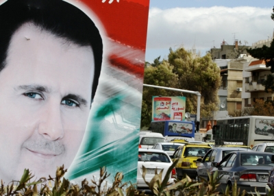A photo taken on March 4, 2015 shows a banner bearing a portrait of Syrian President Bashar al-Assad in a street in the city of Damascus. (Louai Beshara/AFP/Getty Images)