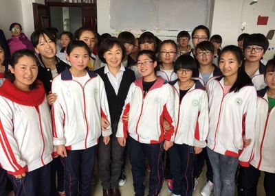 Tien Ching poses with girls in the EGRC program. (Tien Ching)