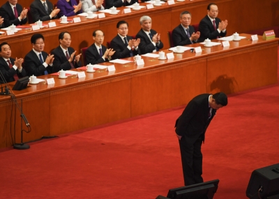 Chinese President Xi Jinping bows to the delegates at the National People's Congress