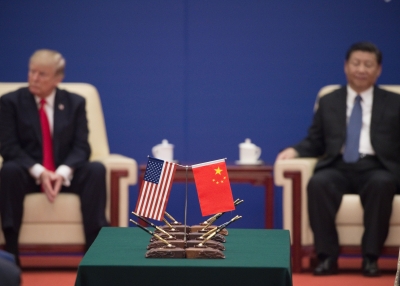 US China flags with Xi Jinping and Trump in background