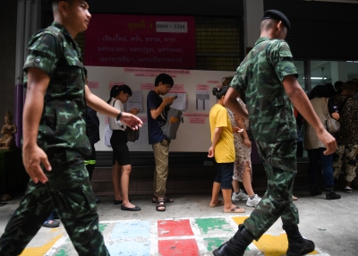 Thai soldiers queue up with others to cast their ballots during early voting in Bangkok on March 17, 2019, ahead of the March 24 general election.