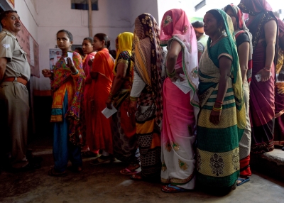Indian voters queue to cast their vote at a polling station during India's general election in Aligarh.