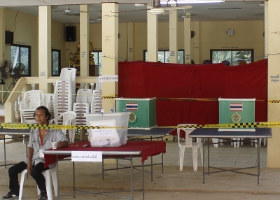 A staff sits inside a polling station in Koh Samui during the 2019 Thai general election