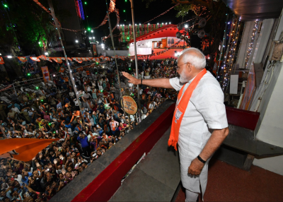After his landslide win, Indian Prime Minister Narendra Modi waves to a group of supporters during his visit to Khanpur, Ahmedabad on May 26, 2019.