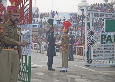 Indian and Pakistani guards shake hands at the Wagah border