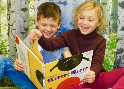 Kindergarten students enjoying a book together.