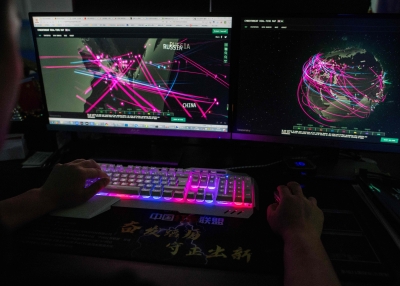A member of the hacking group Red Hacker Alliance uses a website that monitors global cyberattacks on his computer.
