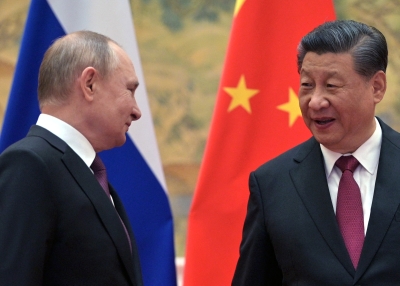 Russian President Vladimir Putin (L) and Chinese President Xi Jinping arrive to pose for a photograph during their meeting in Beijing, on February 4, 2022.