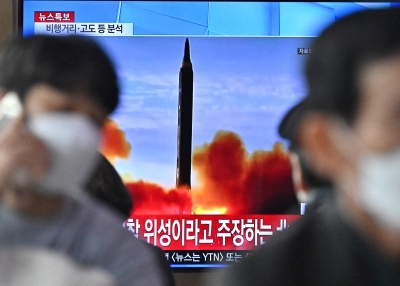People watch a TV at the Seoul Railway Station showing a file image of a North Korean missile launch on March 24, 2022 in Seoul, South Korea. North Korea fired an intercontinental ballistic missile (ICBM) toward the East Sea on Thursday, South Korea's military said, a move sharply escalating tensions in the region.