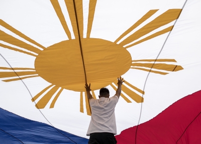 Workers of the National Historical Commission of the Philippines assist in fixing the national flag in Manila 