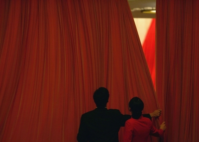 Chinese attendants close the curtains during the closing ceremony of the National People's Congress (NPC), or parliament, at the Great Hall of the People on March 14, 2005 in Beijing, China.
