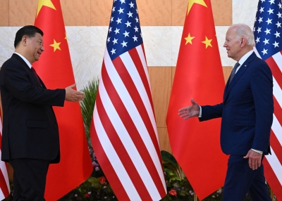 US President Joe Biden (R) and China's President Xi Jinping (L) shake hands as they meet on the sidelines of the G20 Summit in Nusa Dua on the Indonesian resort island of Bali on November 14, 2022. 