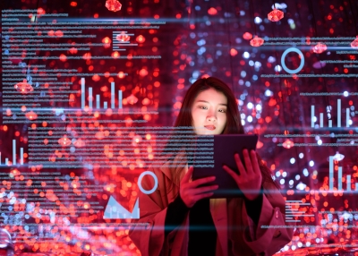 Young woman uses digital tablet on virtual visual screen at night