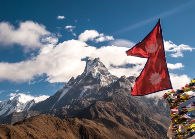 Nepal flag over looking the Himalayan mountains.
