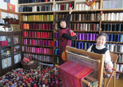 Iwasaki  and Umehara for FuFuFu Fuku in a yarn shop with a loom