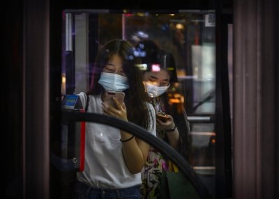 Woman in mask on public transportation