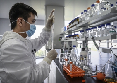 A technician works in a lab at Sinovac Biotech
