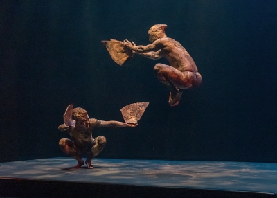 an image of two performers in the show "Ghosts of Hell Creek: Stone Garuda" leaping in the air in costume, facing each other
