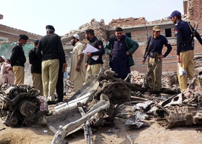 Pakistani police inspect the wreckage of a vehicle used in a suicide bomb attack on a police station in Karak some 150 km (94 miles) southeast of Peshawar on Feb. 27, 2010. (Karim Ullah/AFP/Getty Images)