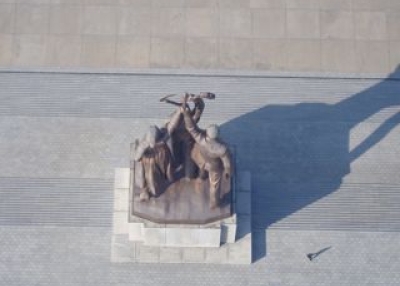A bird's eye view of the statue of the worker, peasant and working intellectual at the base of the Juche Tower. 