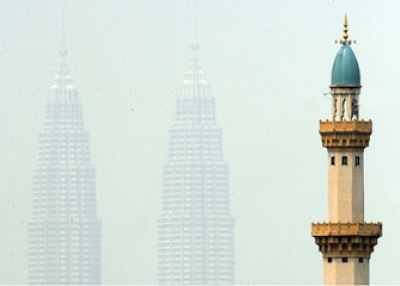 Malaysia's landmark Petronas Twin Towers behind the minaret of a mosque in Kuala Lumpur on June 12, 2009. (Saeed Khan/AFP/Getty Images)