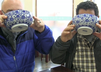 Howie Southworth (left) and Greg Matza drink the broth from bowls of soup.