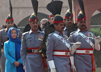US Secretary of State Hillary Clinton (2nd L in blue) is escorted by Pakistan Rangers as she arrives at the tomb of Pakistan's national poet Allama Mohammad Iqbal during her visit to Lahore on October 29, 2009. (STR/AFP/Getty Images)