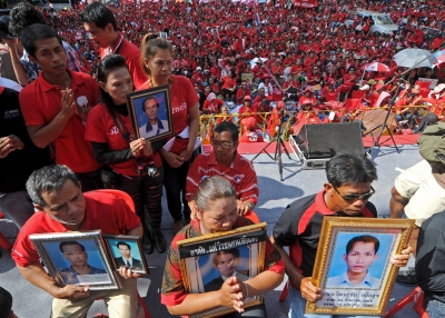 "Red shirt" supporters hold portraits of dead protesters during a demonstration to mark the second anniversary of a deadly crackdown on street protests in Bangkok on May 19, 2012. (AFP/Getty Images)