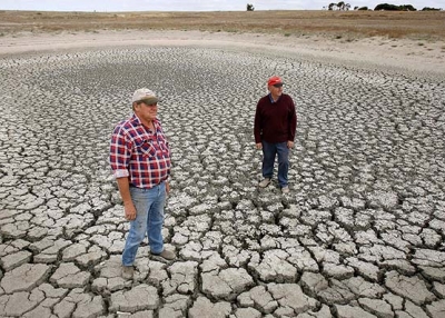 Farmers inspect an empty dam. Severe drought has crippled agriculture in Australia (William West/AFP/Getty Images)