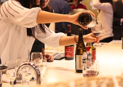 Asia Society volunteers pour glasses of Treaty Port Vineyards wine (Ranna Iglesias Asia Society).