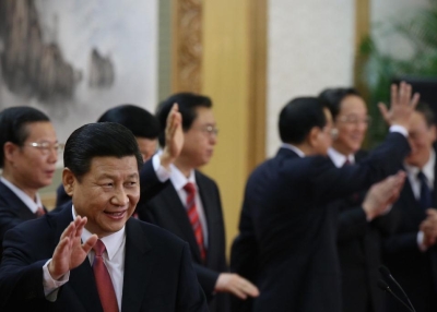 Xi Jinping (2nd from left) waves in front of fellow members of the new Politburo Standing Committee at the Great Hall of the People in Beijing on November 15, 2012. (Feng Li/Getty Images)