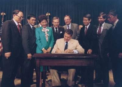 U.S. President Ronald Reagan signing the Japanese reparations bill