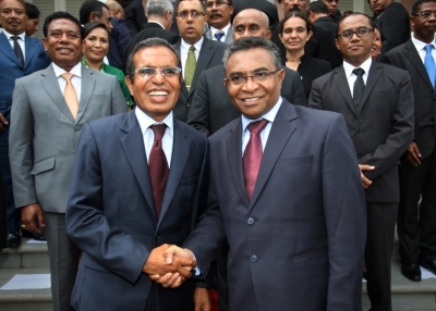 East Timor's new Prime Minister Rui Araujo (R) and President Taur Matan Ruak (L) shake hands as they pose for a group photograph after a swearing ceremony in Dili on February 16, 2015. VALENTINO DE SOUSA / AFP / Getty Images  