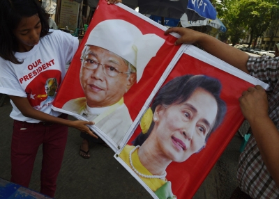 Supporters of the National League for Democracy (NLD) hold a banner displaying the portraits of new Myanmar President Htin Kyaw (L) and democracy icon Aung San Suu Kyi (R) in Yangon on April 10, 2016 ahead of the Thingyan new year festival. (ROMEO GACAD/AFP/Getty Images)