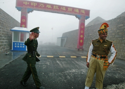 On July 10, 2008 a Chinese soldier and an Indian soldier stand guard at the Chinese side of the ancient Nathu La border crossing between India and China. (Diptendu Dutta/AFP/Getty Images)