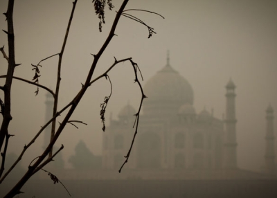 India's Taj Mahal, visible through the surrounding haze, at sunrise. (Tine Steiss/Flickr)