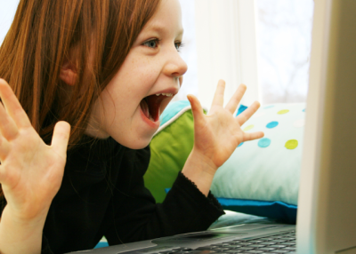 A child reacts in excitement (killerb10/iStockPhoto)