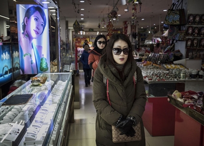 Chinese shoppers walk through a small department store in a shopping district in central Beijing, China. (Kevin Frayer/Getty Images)